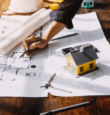 Stylized gold logo showing rooftops, a high-rise building, and a road representing Jeffrin Construction & Interior