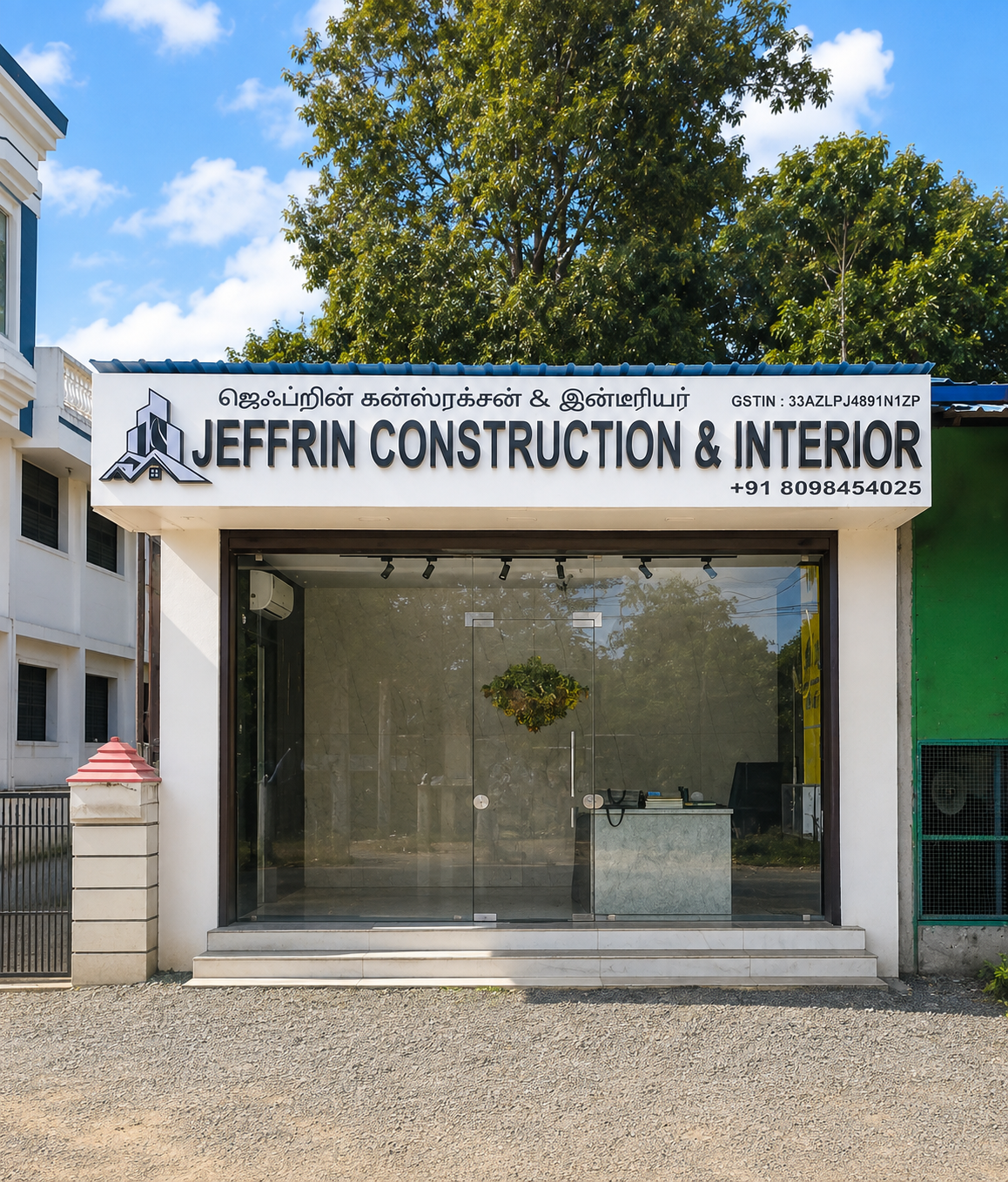 Stylized gold logo showing rooftops, a high-rise building, and a road representing Jeffrin Construction & Interior